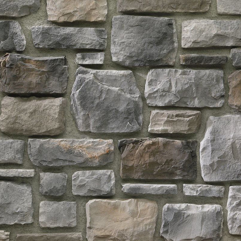 Close-up of a stone wall with variously shaped and sized stones.