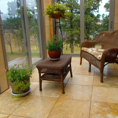 Wicker furniture set with potted plants on a tiled patio