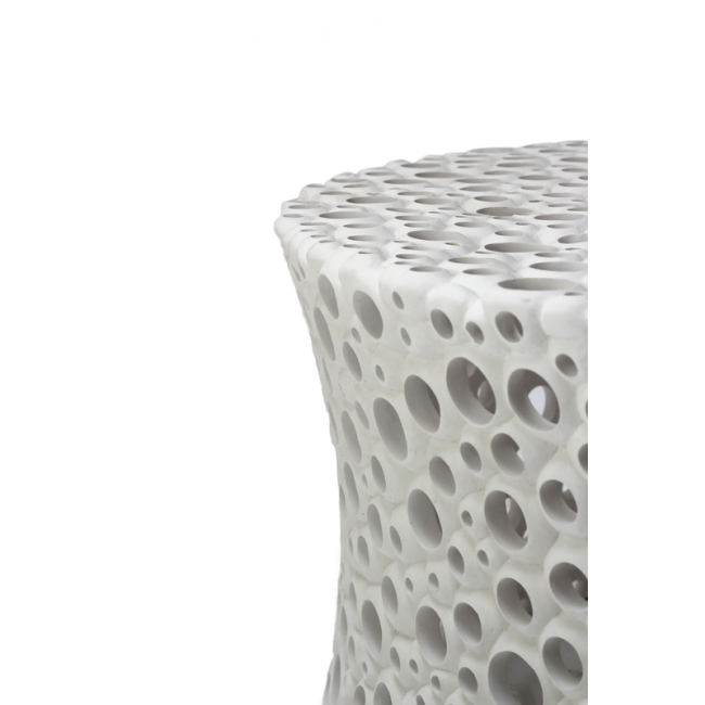 White ceramic stool with a textured, bubble-like design on a white background