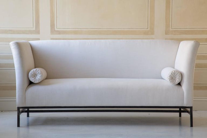 Contemporary Linen Sofa with Iron Base by Tara Shaw shown on white floor and cream walls