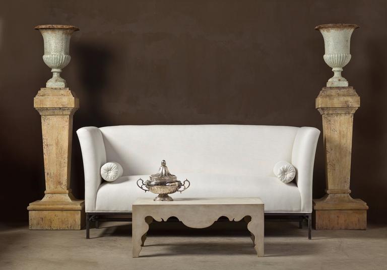 Contemporary Rococo Coffee Table in Painted Swedish Finish by Tara Shaw pictures with white sofa and two pillars with white urns sitting on top